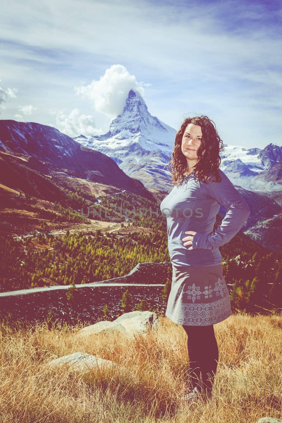 Young woman enjoying a view in the mountains near Swiss resort town of Zermatt