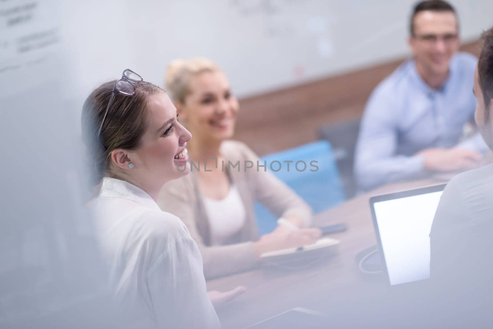 Group of a young business people discussing business plan at modern startup office building