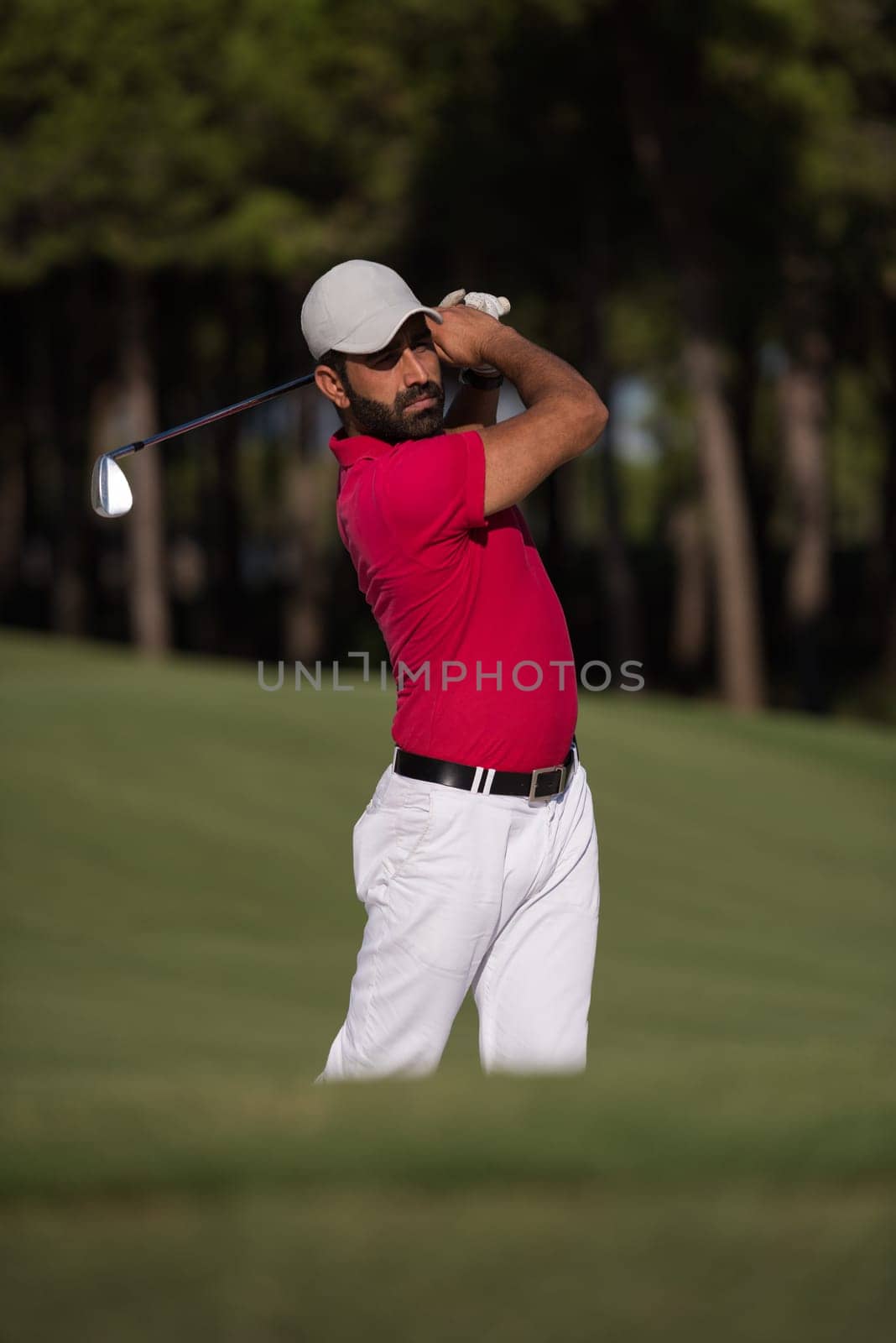 golf player shot ball from sand bunker at course