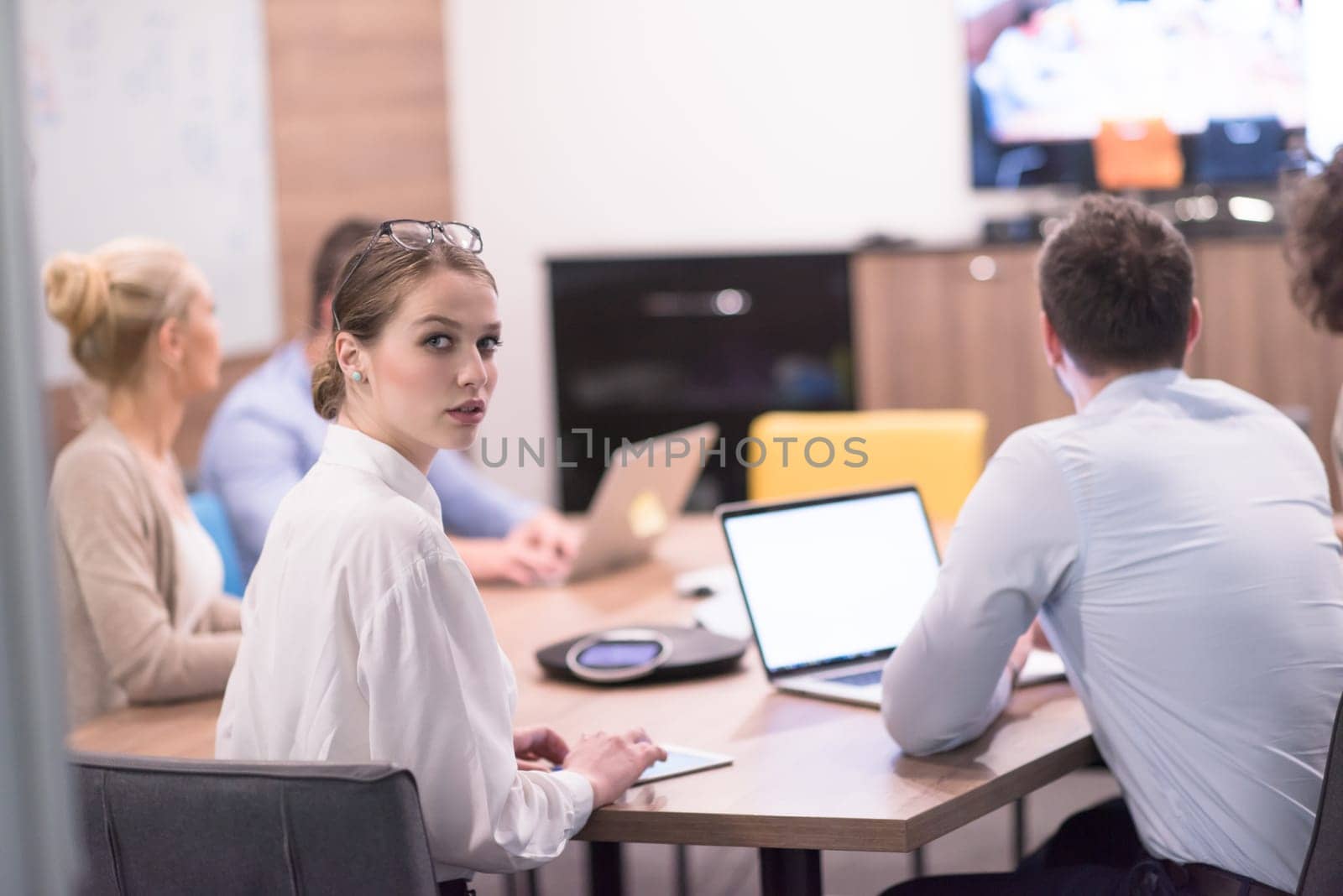 Group of a young business people discussing business plan at modern startup office building