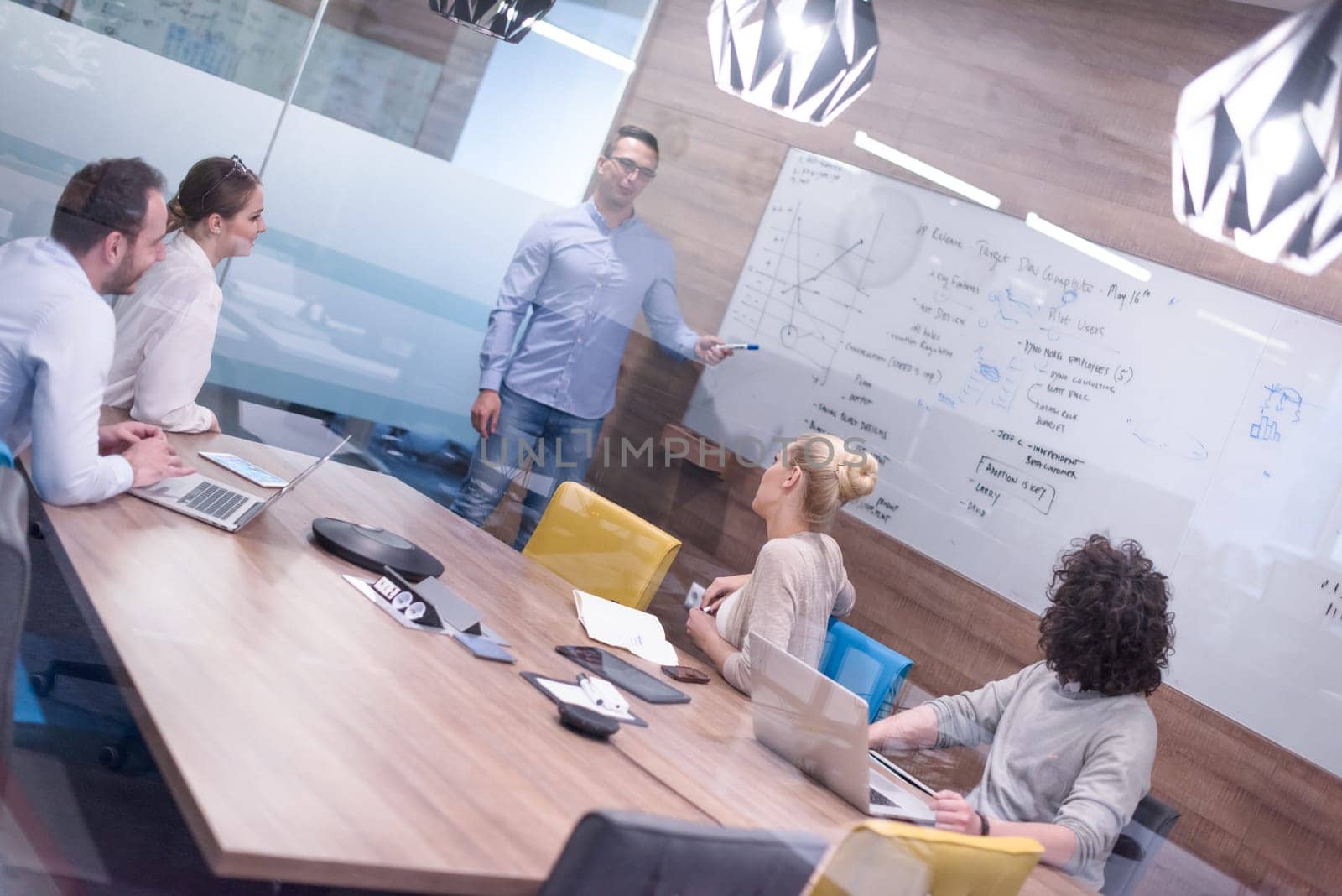 Group of a young business people discussing business plan at modern startup office building