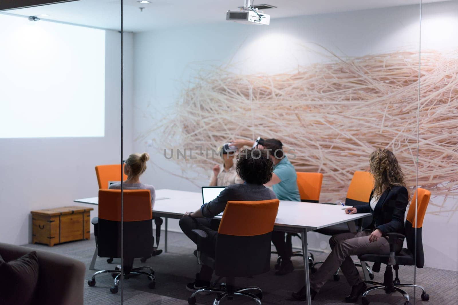startup Business team using virtual reality headset in night office meeting  Developers meeting with virtual reality simulator around table in creative office.