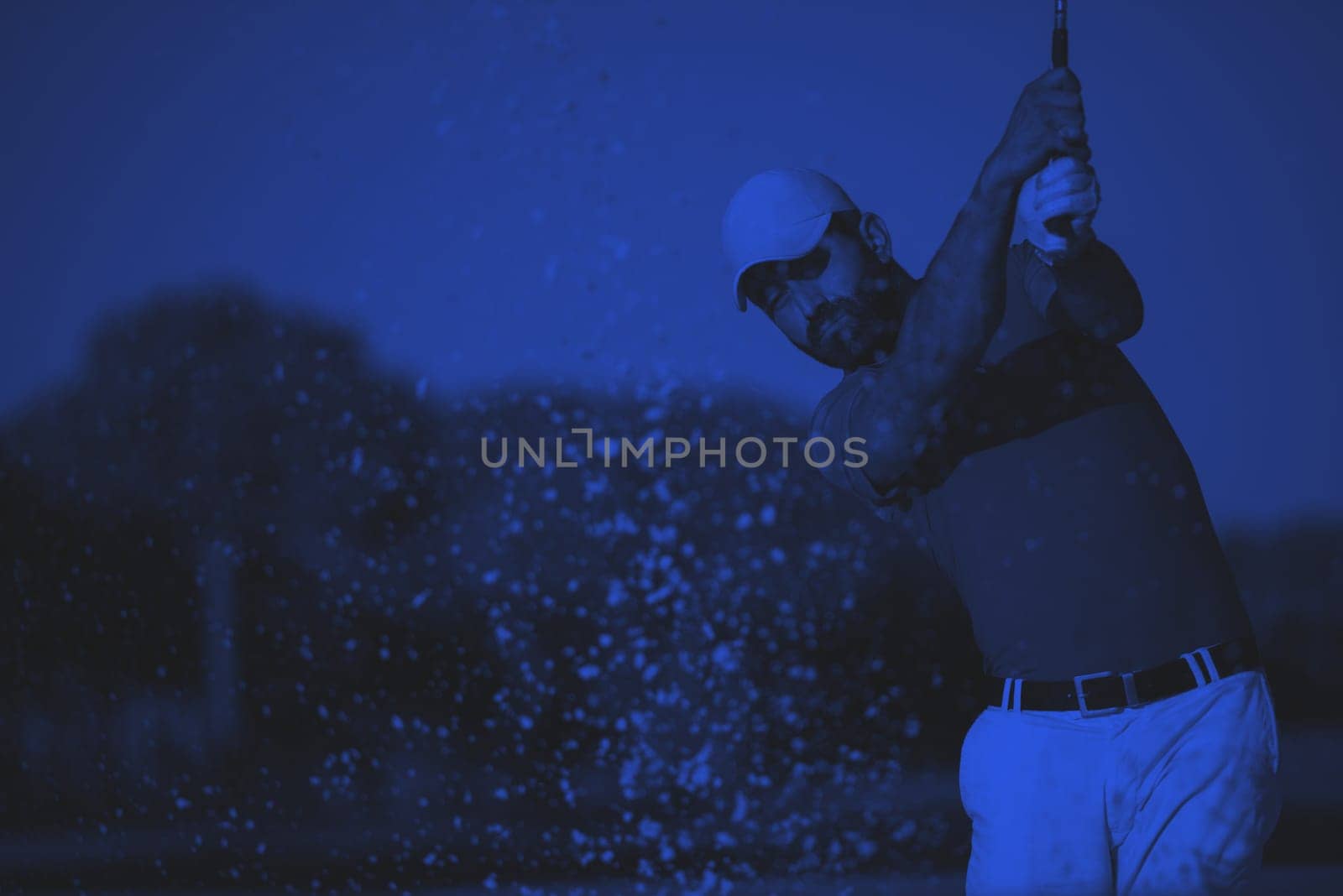 pro golf player shot ball from sand bunker at course duo tone