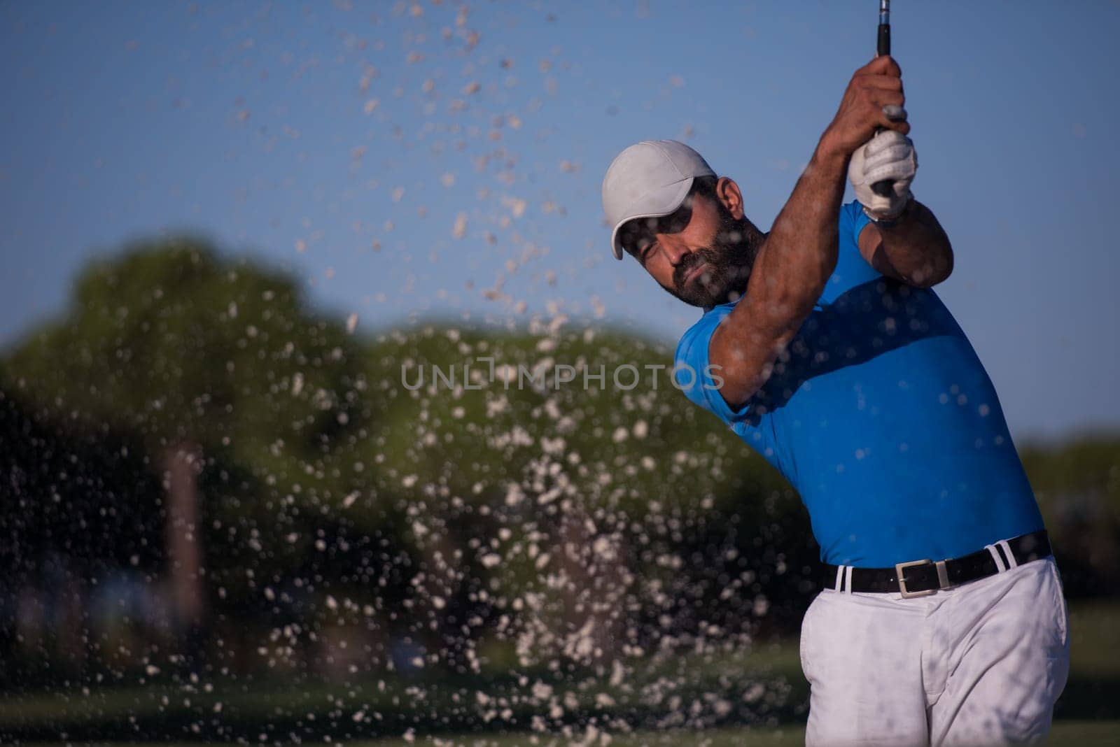 pro golf player shot ball from sand bunker at course