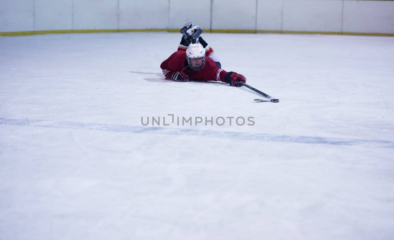 young ice hockey player portrait on training in black background