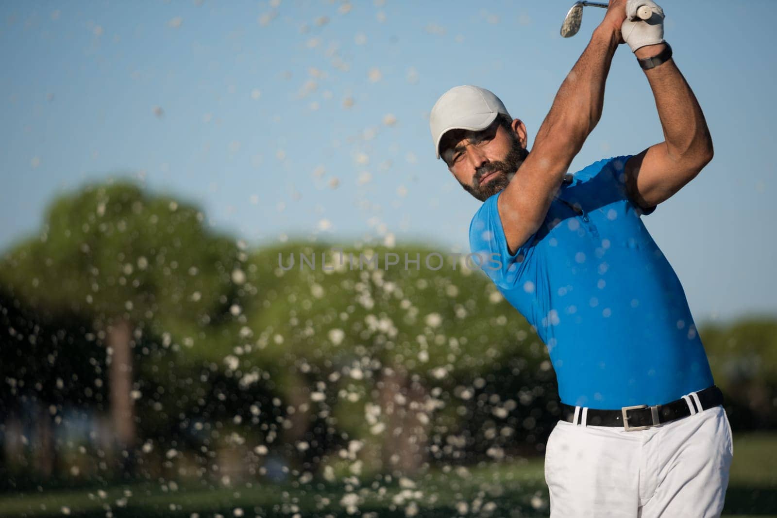 pro golf player shot ball from sand bunker at course