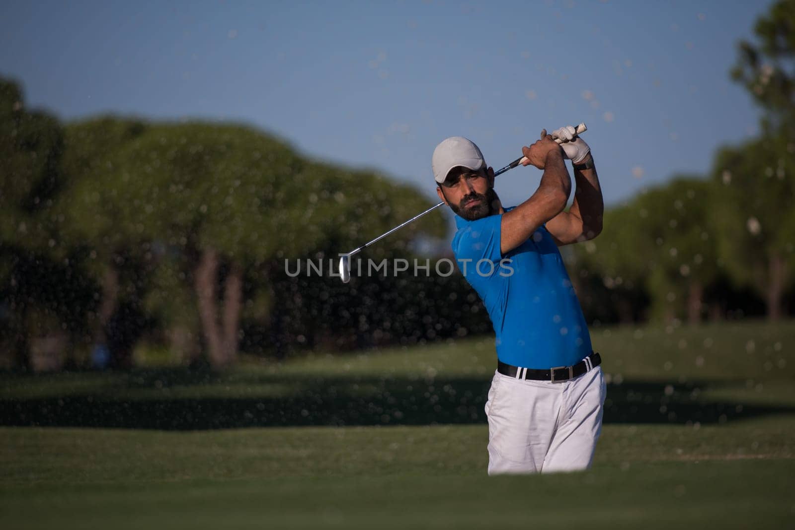 pro golf player shot ball from sand bunker at course