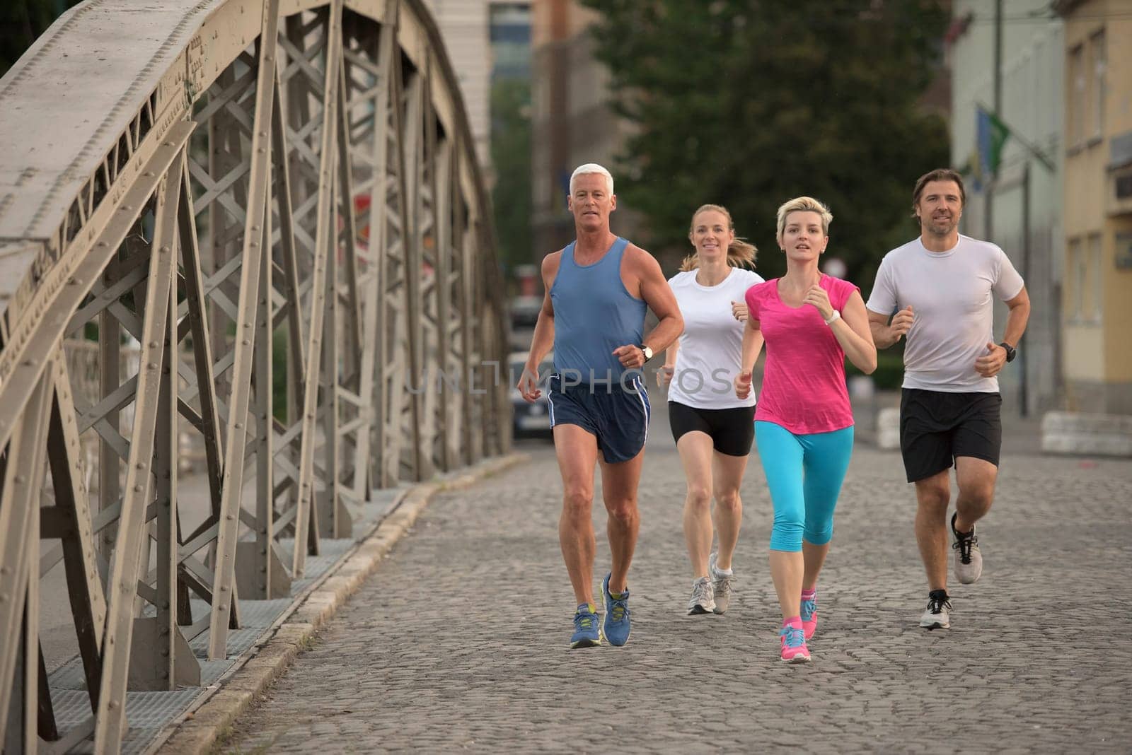 people group jogging  runners team on morning  training workout with sunrise in background