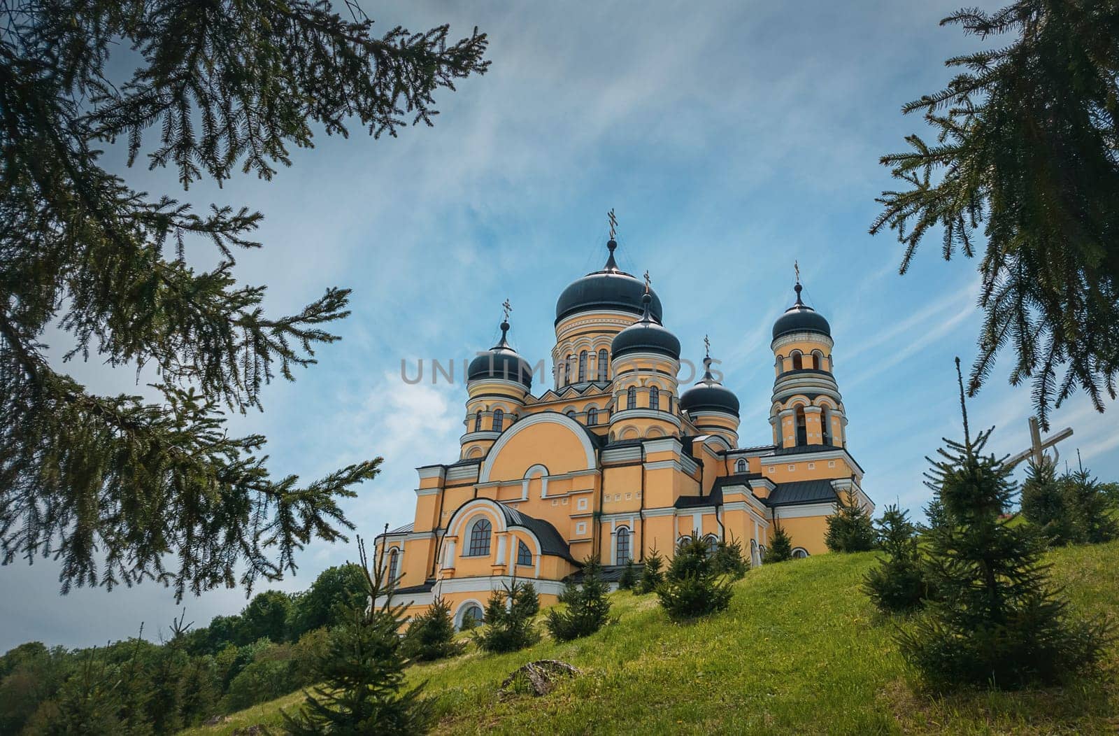 Beautiful outdoors view to Hancu Monastery, a traditional Christian Orthodox church located in the middle of the woods, Republic of Moldova. Eastern Europe basilica traditional architecture style