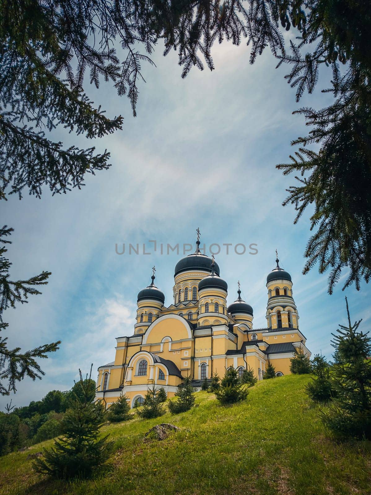 Beautiful outdoors view to Hancu Monastery, a traditional Christian Orthodox church located in the middle of the woods, Republic of Moldova. Eastern Europe basilica traditional architecture style