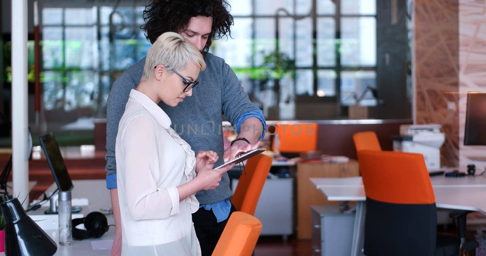 two business people using tablet  preparing for next meeting and discussing ideas