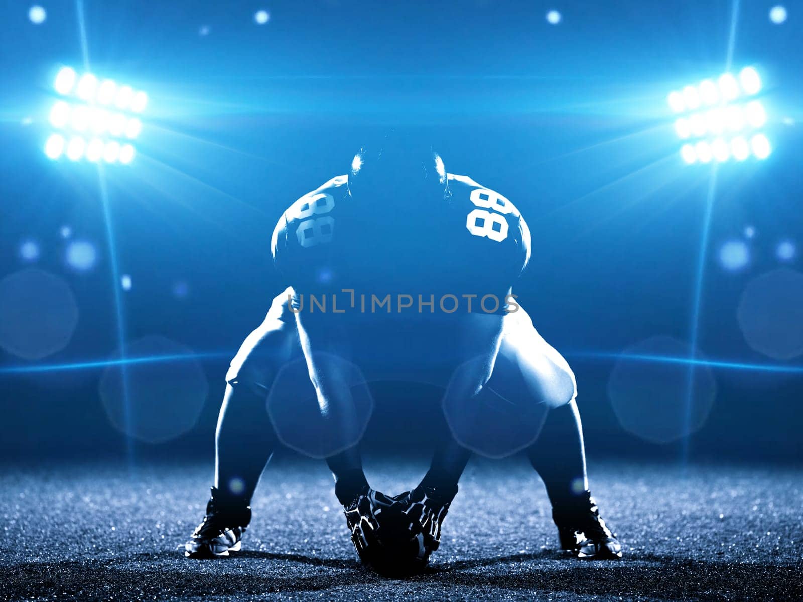 American football player starting football game on american football field at night