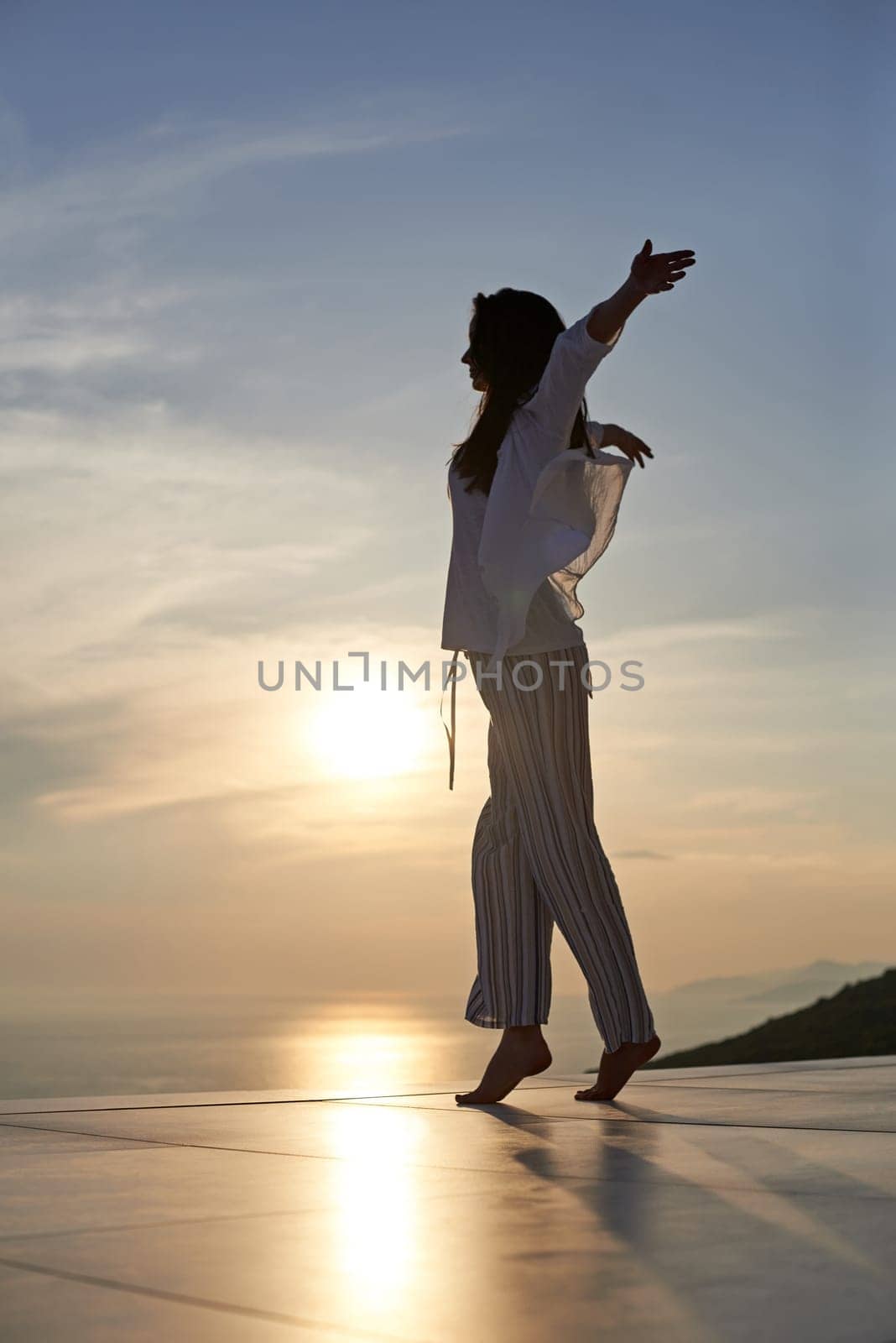 happy young woman enjoy sunset while dancing and enjoy music on headphones