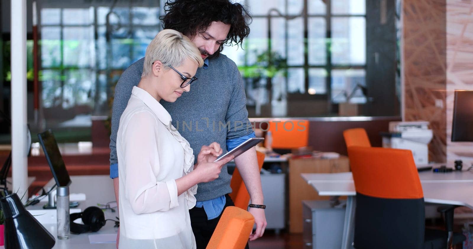 two business people using tablet  preparing for next meeting and discussing ideas