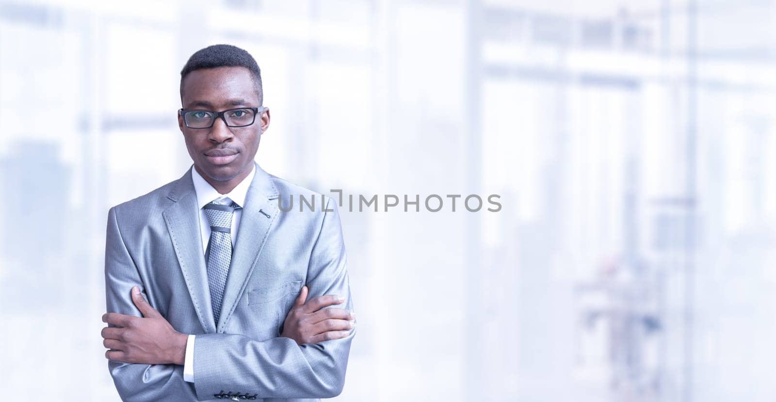 Portrait of young junior businessman in front of his big modern office