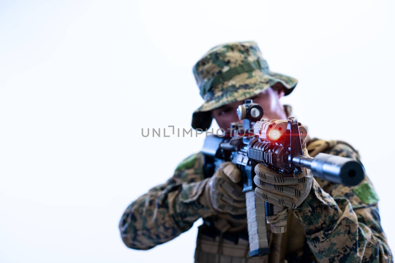 modern warfare american marines soldier in action while sneaking and aiming  on laseer sight optics  in combat position and  searching for target in battle