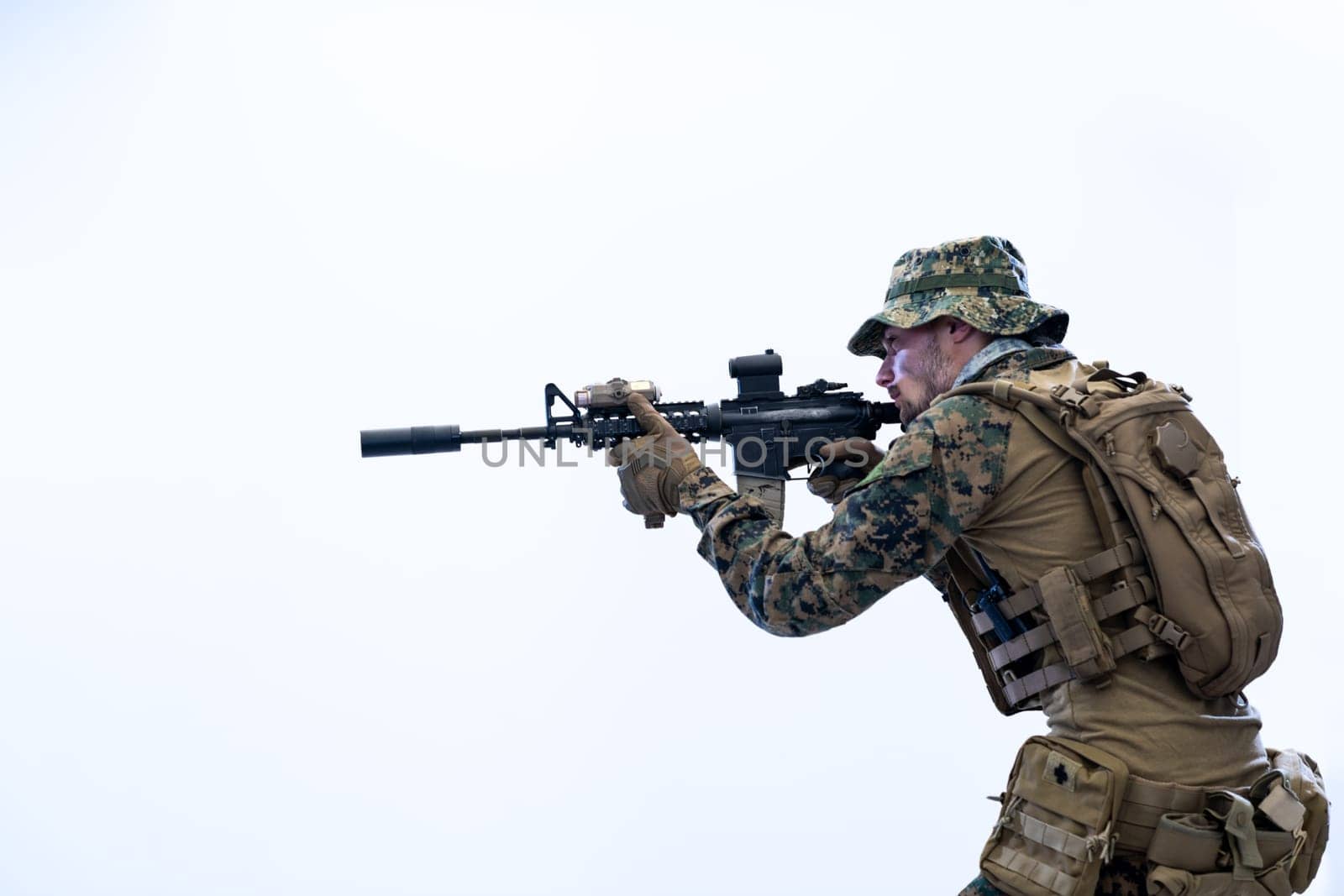 modern warfare american marines soldier in action while sneaking and aiming  on laseer sight optics  in combat position and  searching for target in battle