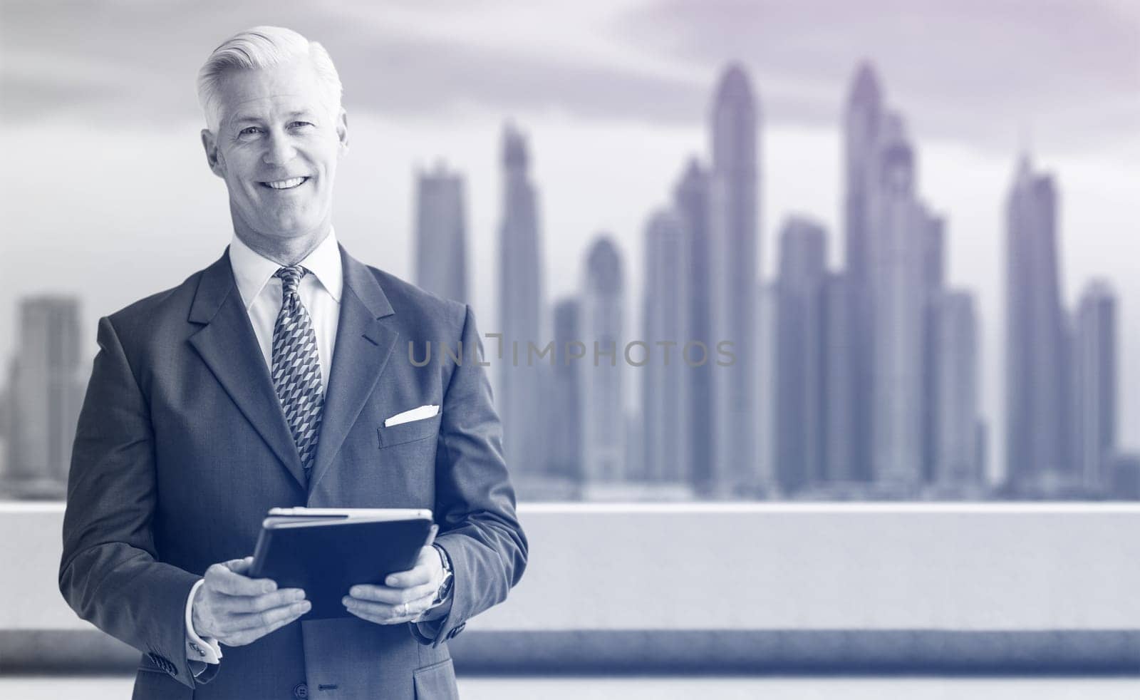 Portrait of senior businessman in front of the big city