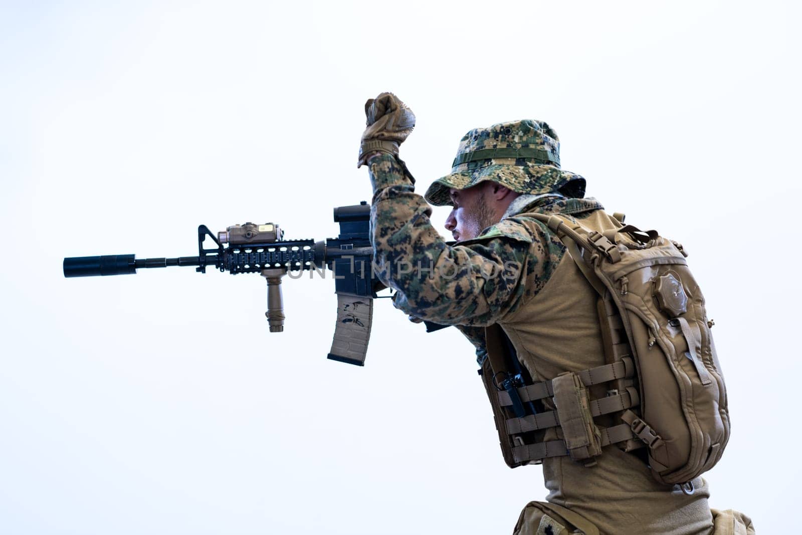 modern warfare american marines soldier in action while sneaking and aiming  on laseer sight optics  in combat position and  searching for target in battle