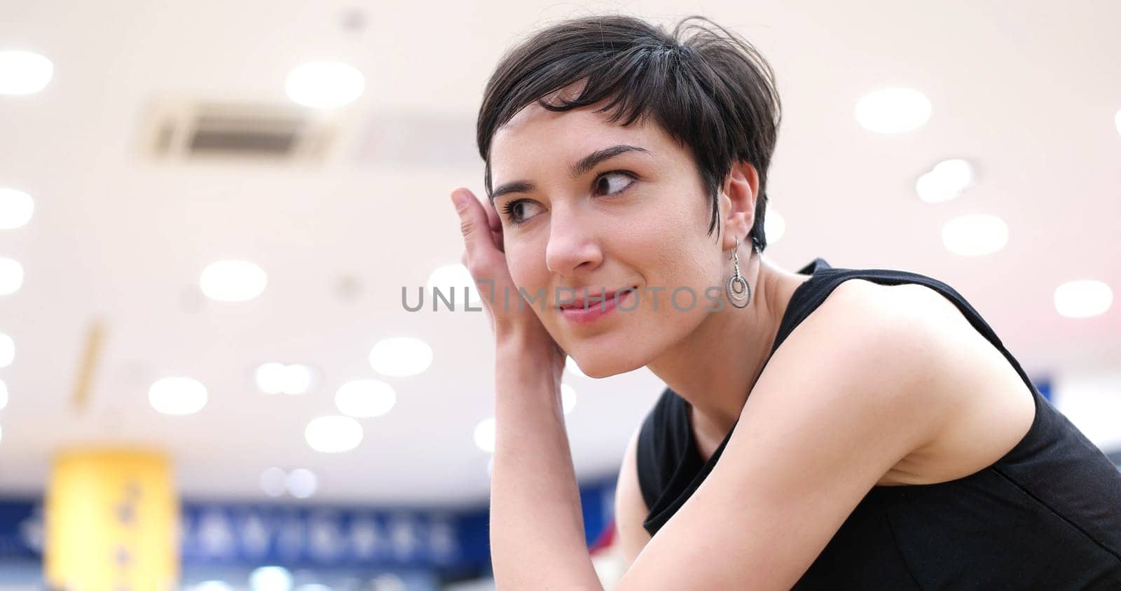 Woman Chooses  Shoes At Fashionable Shop