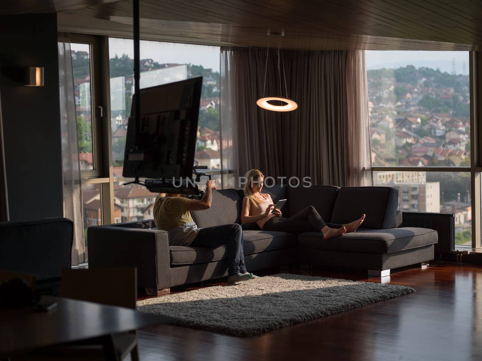 woman using technology on sofa in modern apartment