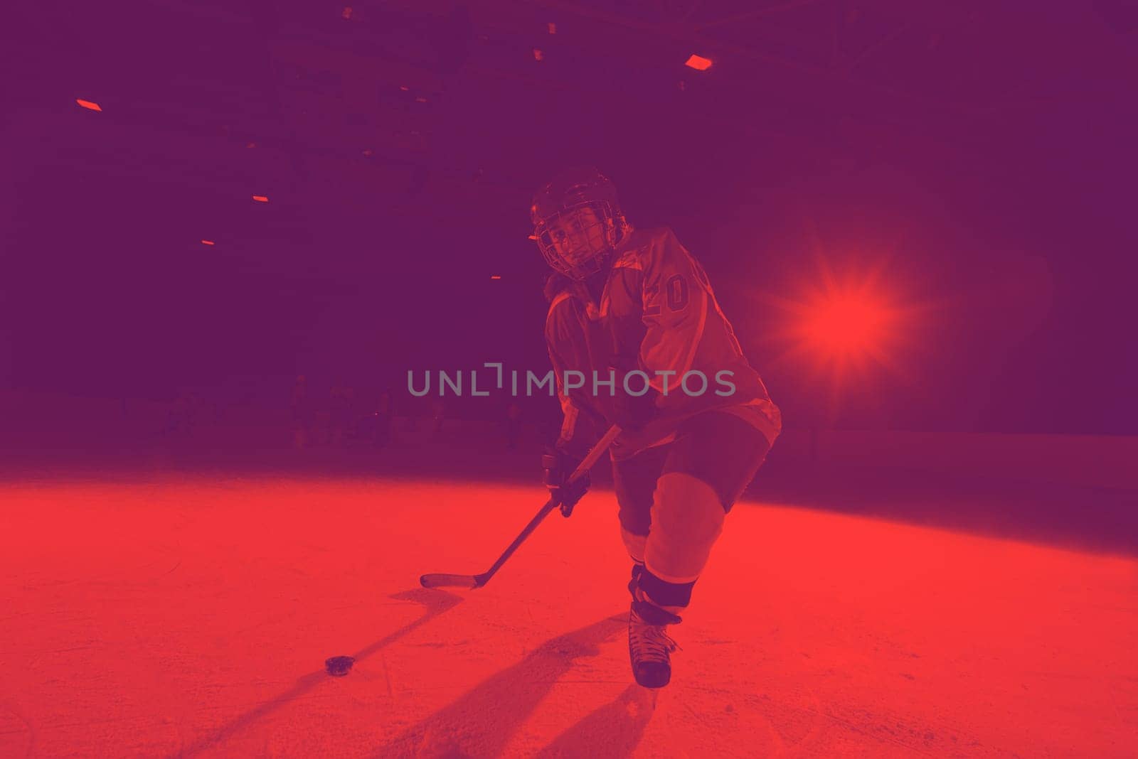 teen girl children ice hockey player in action kicking puck with stick
