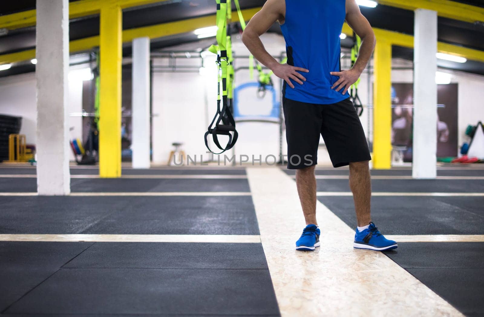 Young strong man doing pushups  at cross fitness gym