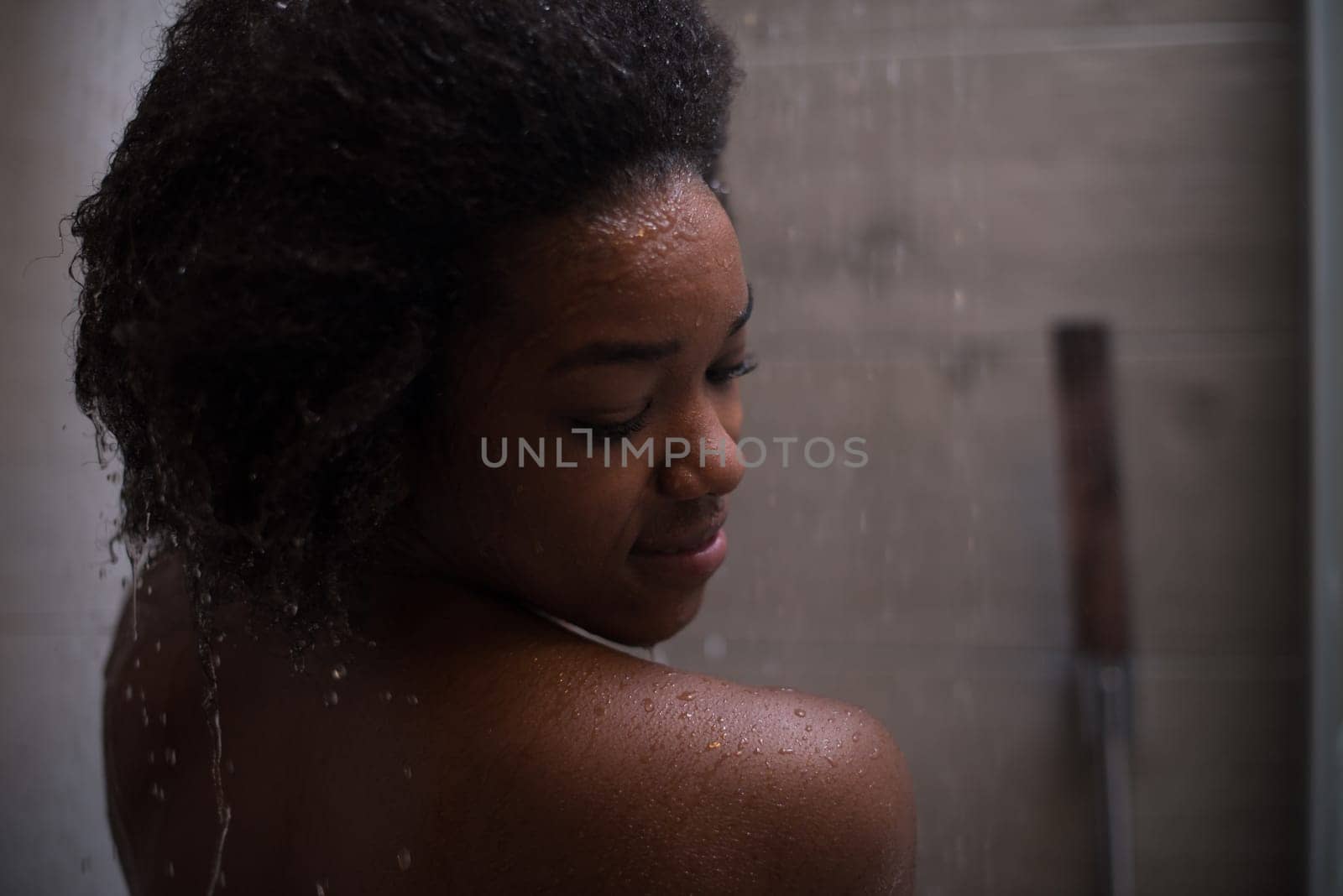Woman in the shower,beautiful black young female showering under refreshing water, healthy lifestyle, enjoying time in luxury spa resort