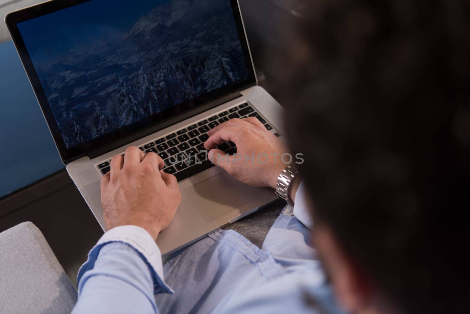 technology, home and lifestyle concept  of man working from home using laptop computer and sitting on sofa
