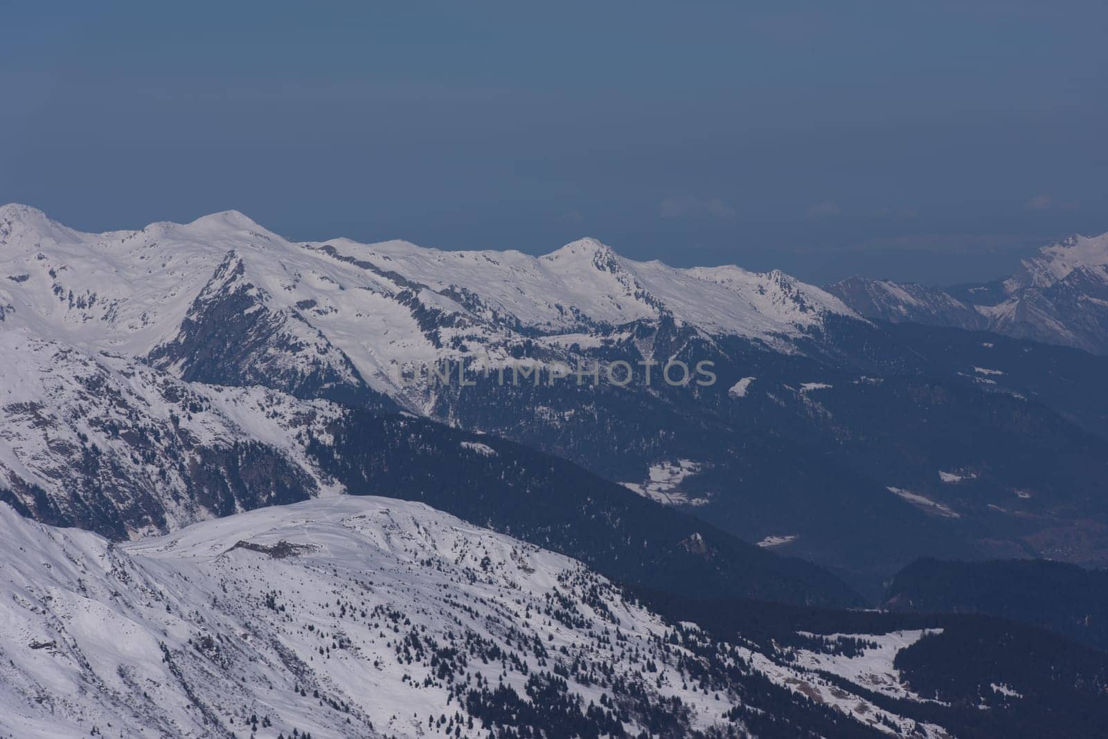 mountain landscape at winter with fresh snow on beautiful sunny day at french alps