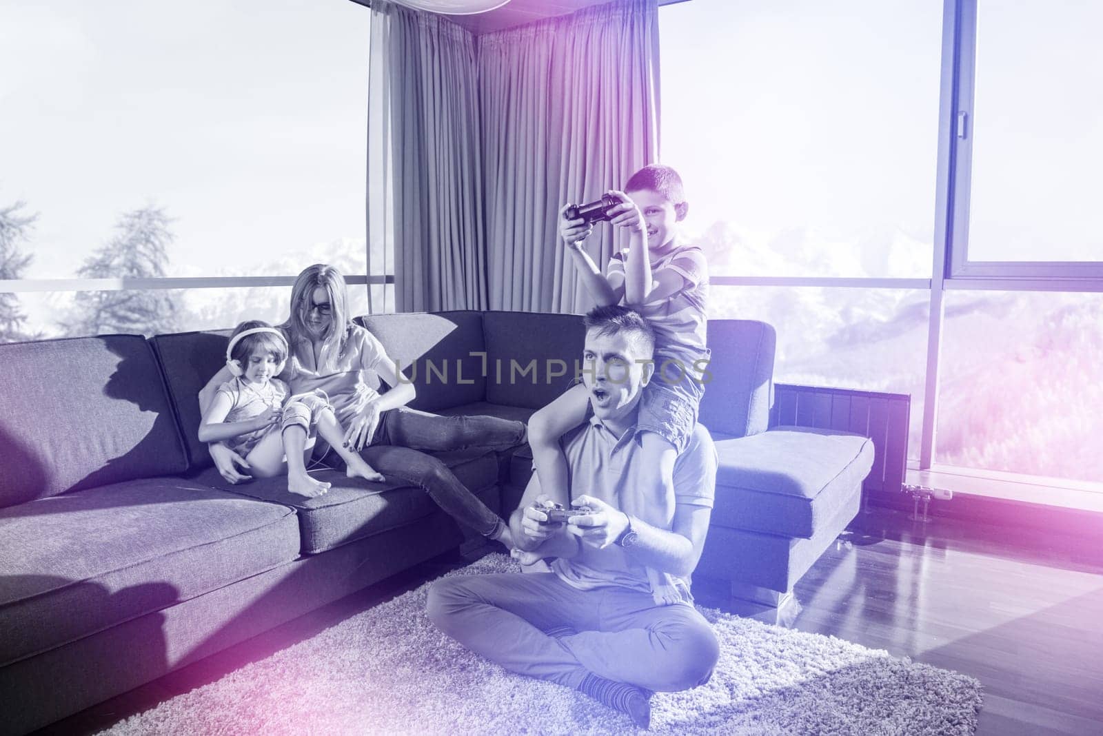 Happy family. Father, mother and children playing a video game Father and son playing video games together on the floor