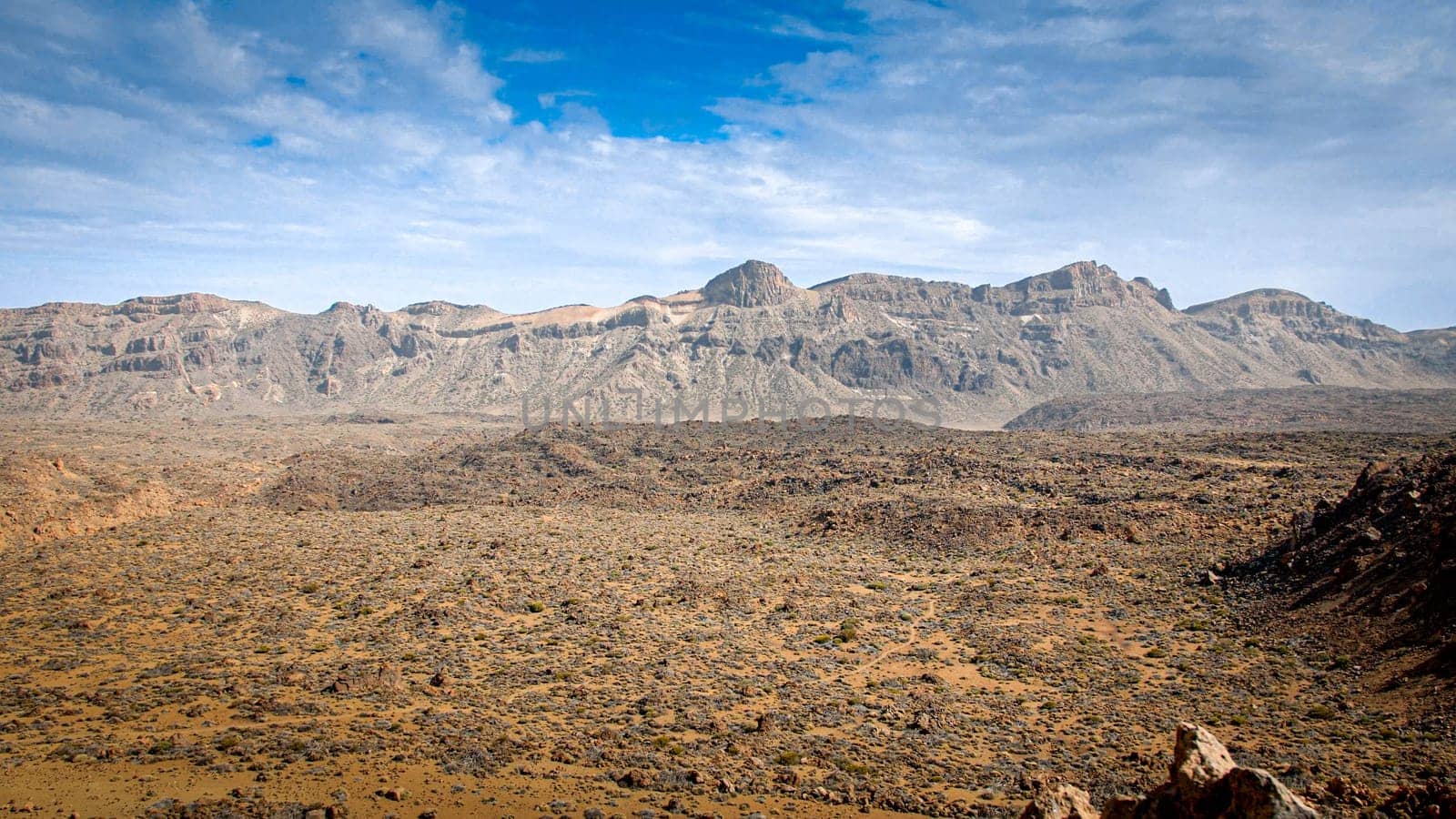 Landscape of rocky desert and mountain valley at bright sunny day. Mars terrain landscape.