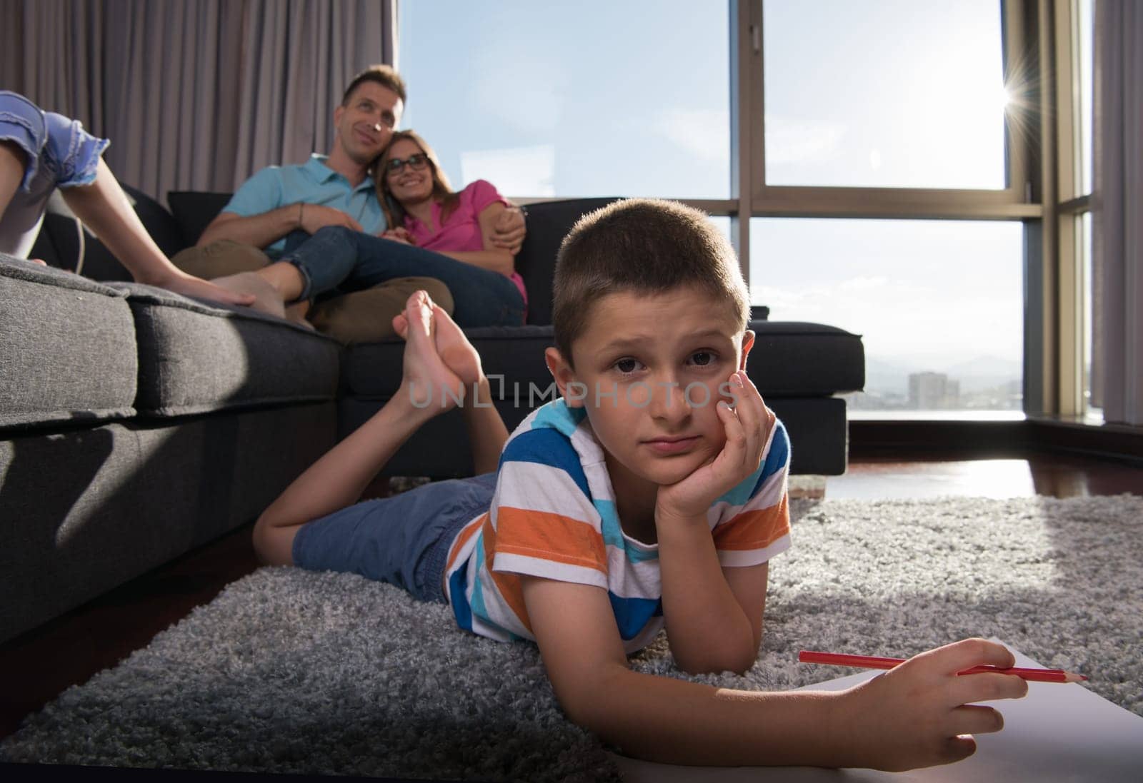 Happy Young Family Playing Together at home on the floor using a tablet and a children's drawing set