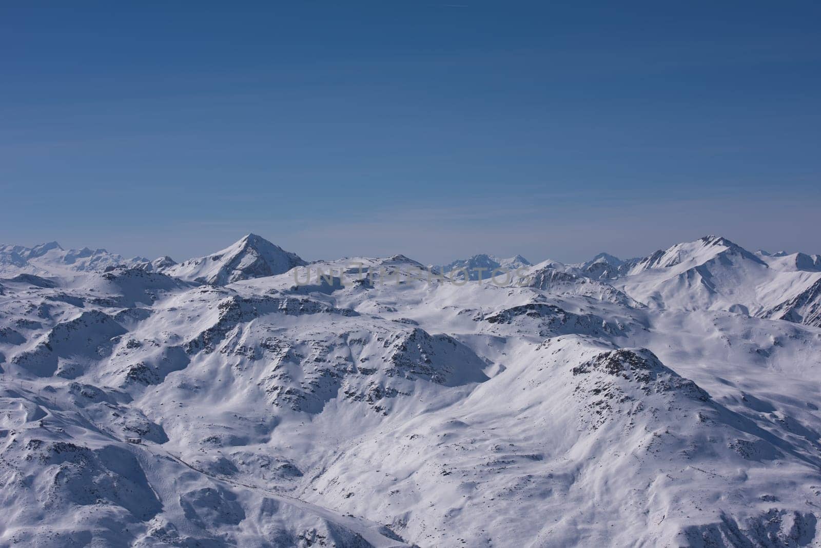 mountain landscape at winter with fresh snow on beautiful sunny day at french alps
