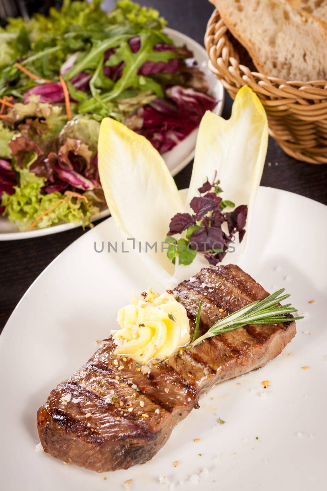 Succulent grilled beef fillet steak with homemade herb butter on a plate