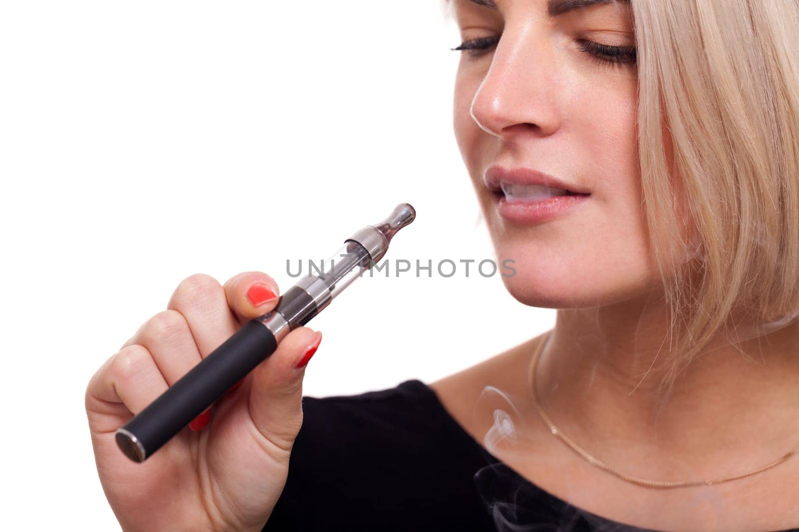 Young woman smokes an e-cigarette with blonde hair portrait isolated against white background