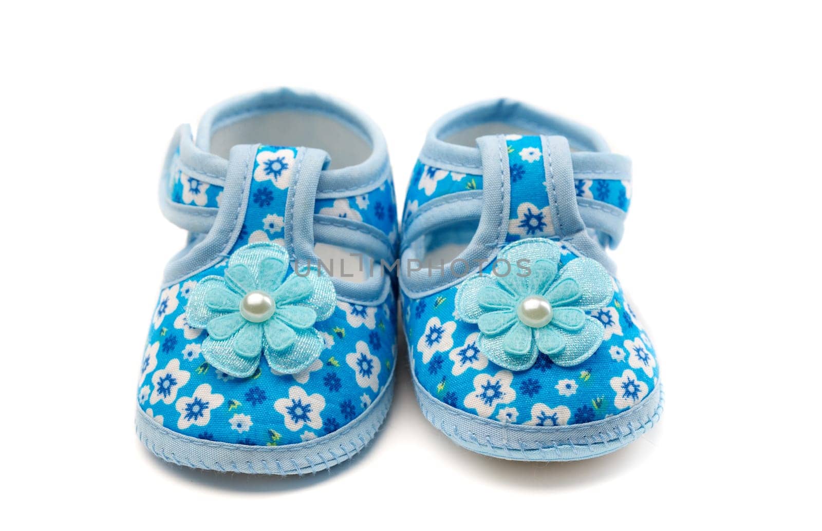 A pair of blue baby shoes. Isolate on white.