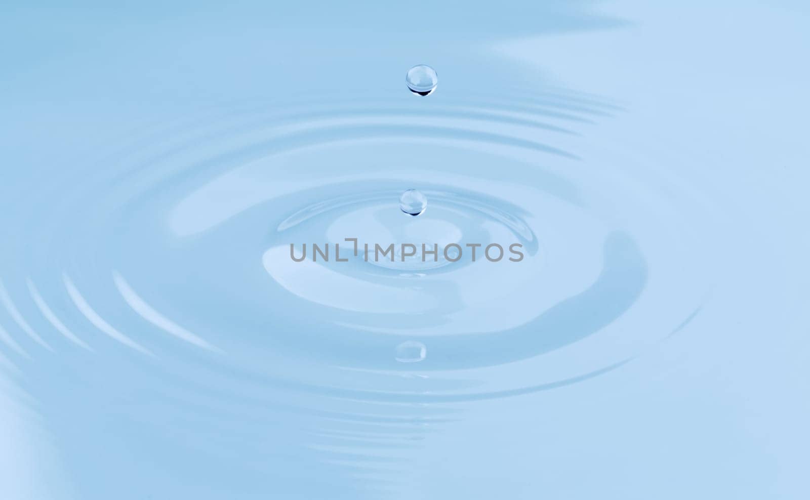 Two drop of water falls leaving footprints in the surface of the water.