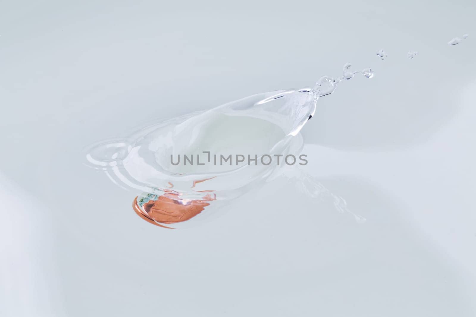One euro cent coin falling into water