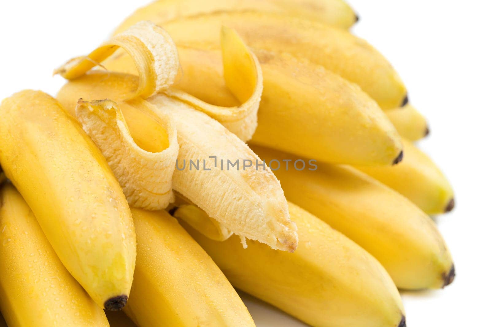 Bunch of bananas with open one isolated on white.