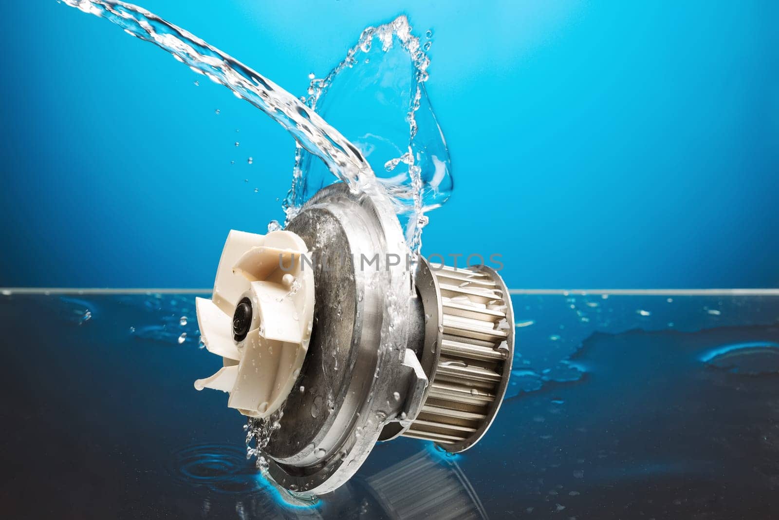 Auto parts, engine cooling pump in water splash on blue gradient background