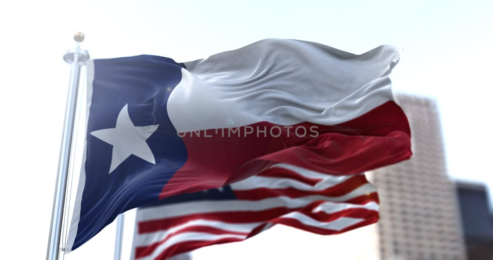 The Texas state flag flapping in the wind with the American national flag blurred in the background. Democracy and independence. American South Central state.