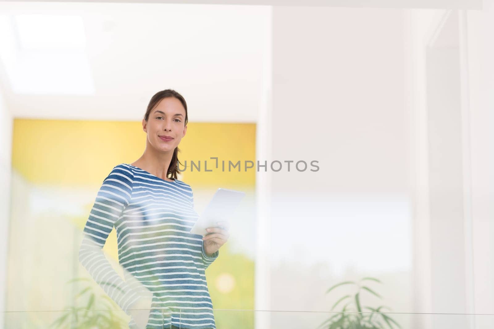 beautiful young woman at home websurfing on internet with tablet