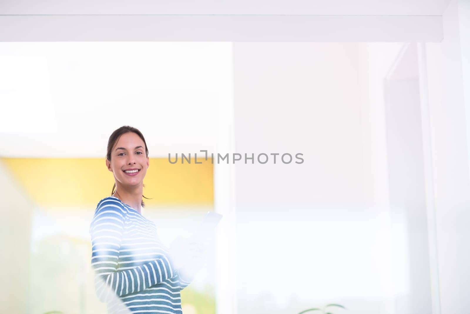 beautiful young woman at home websurfing on internet with tablet