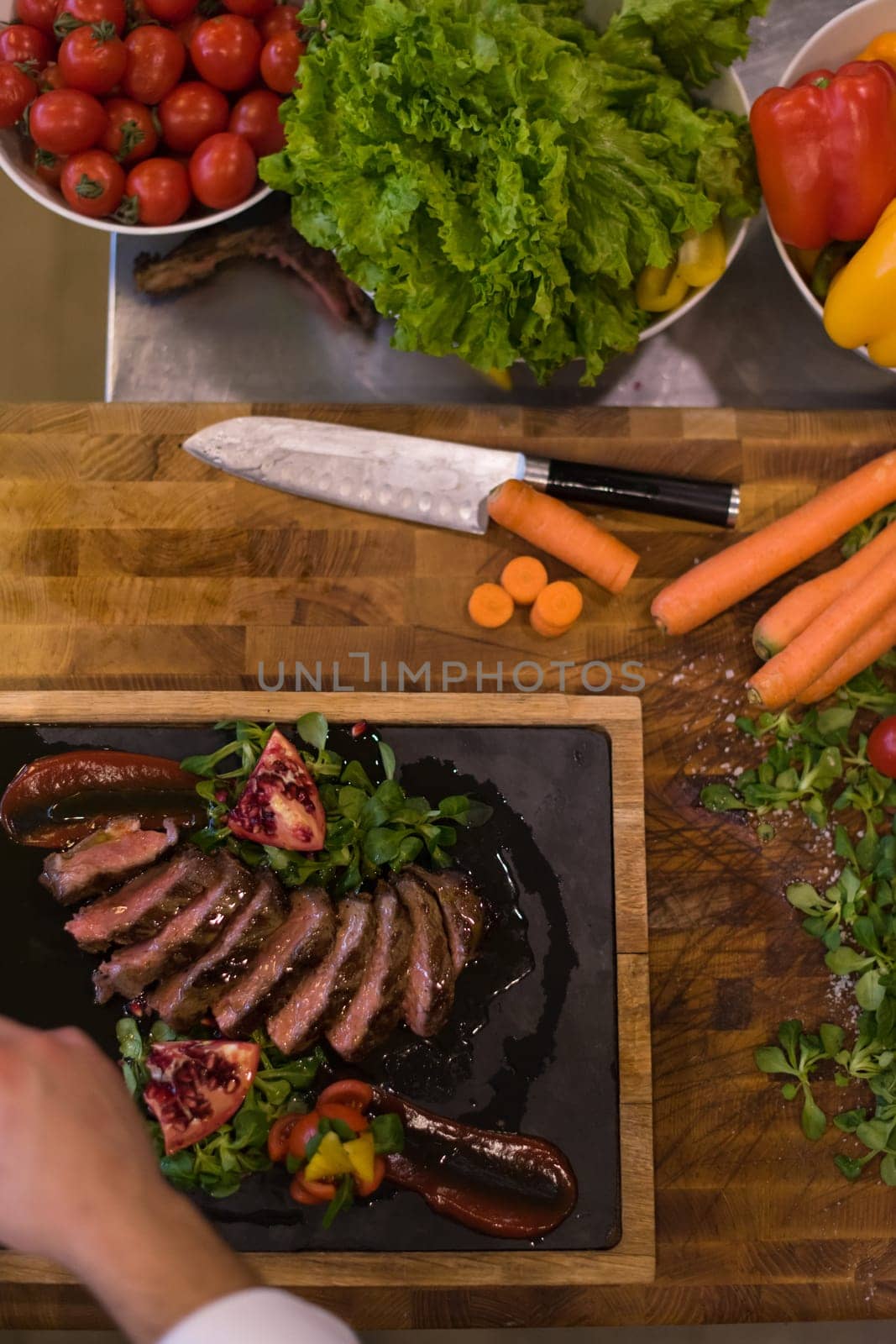 Chef finishing steak meat plate with Finally dish dressing and almost ready to serve at the table  top view