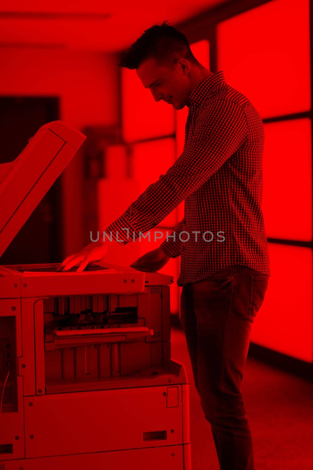 young business man copy documents on copy machine at modern startup office interior, casual clothes