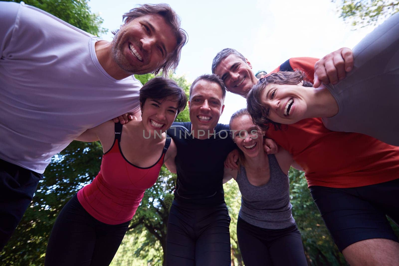 jogging people group, friends have fun,  hug and stack hands together after training