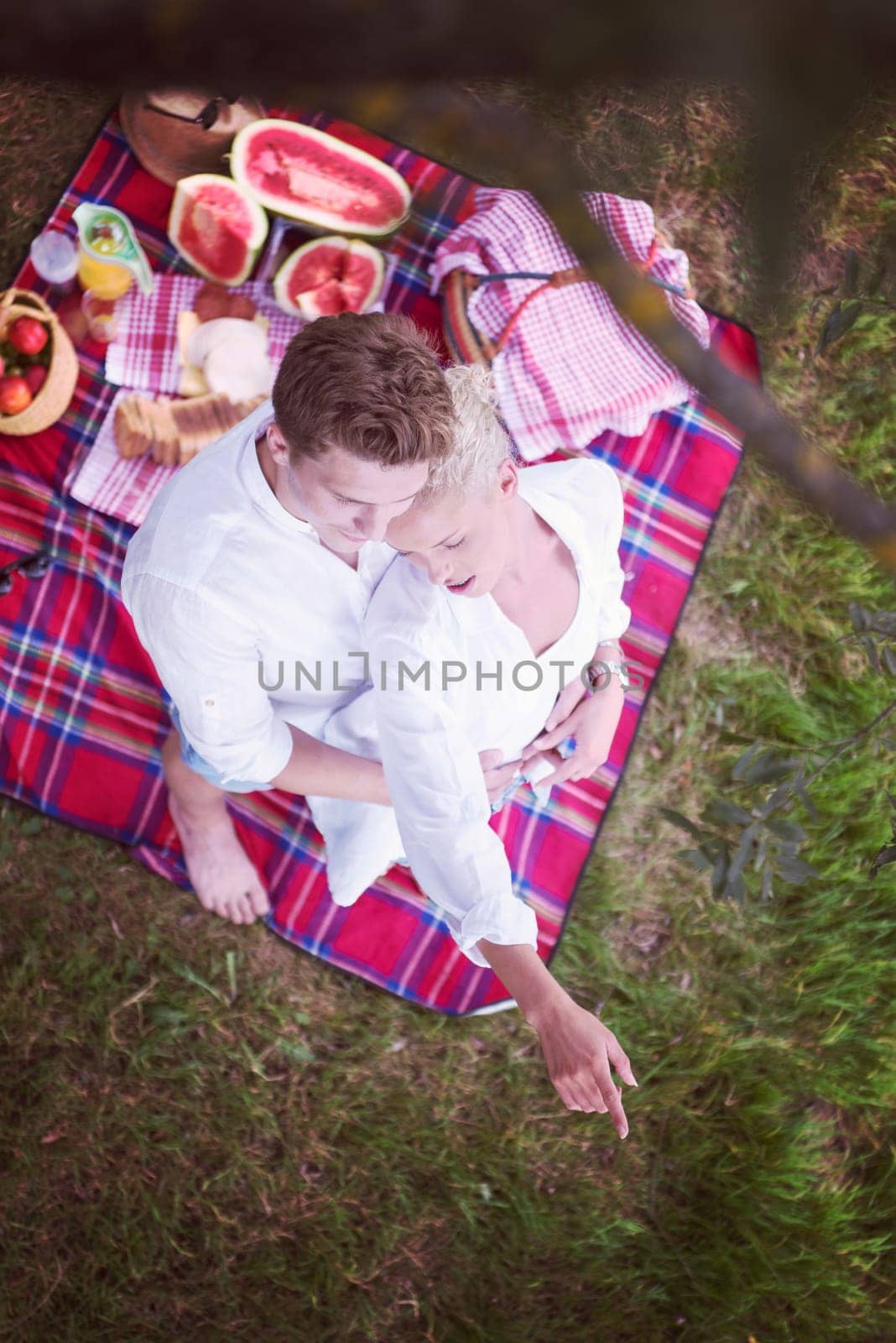Couple in love enjoying picnic time drink and food in beautiful nature on the river bank top view
