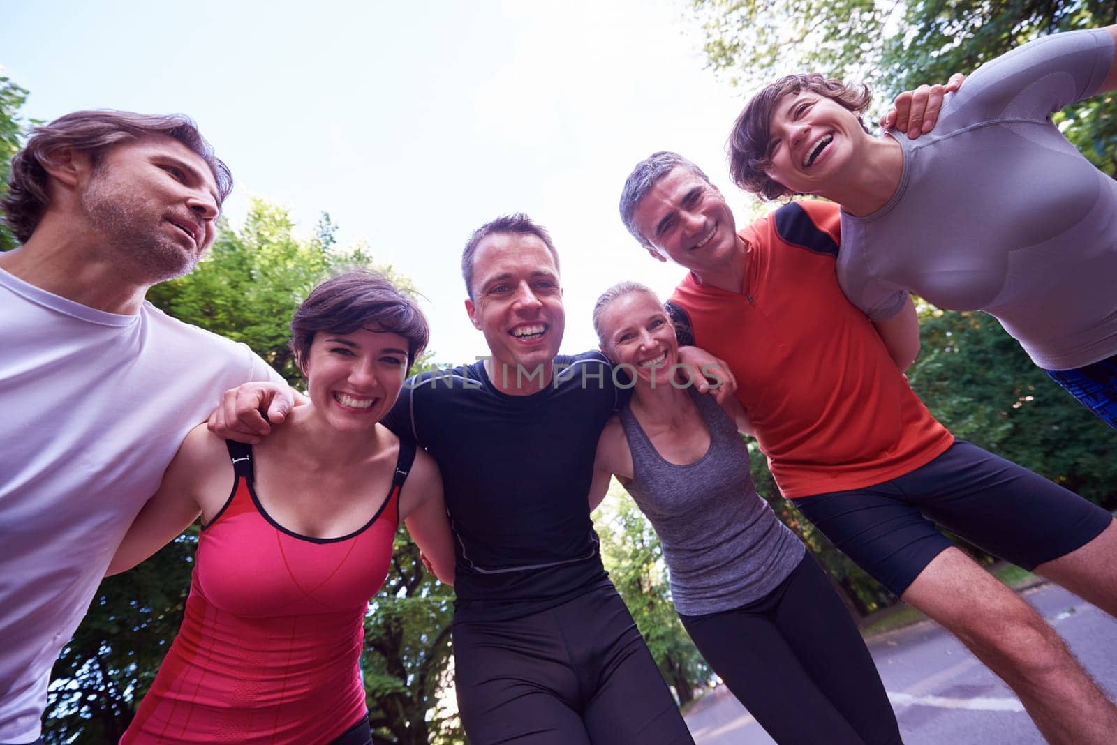 jogging people group, friends have fun,  hug and stack hands together after training