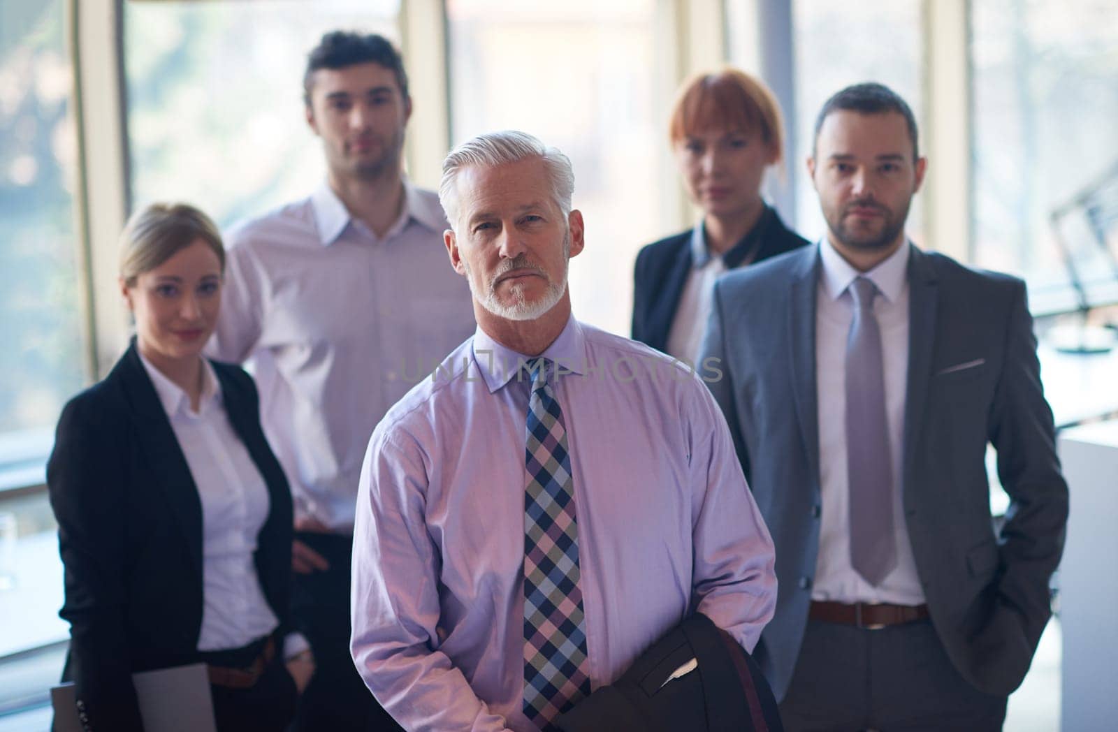 senior businessman with his team at office. business people group